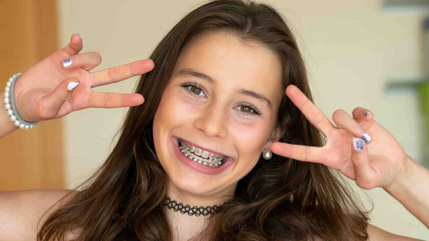 A smiling girl showing her braces