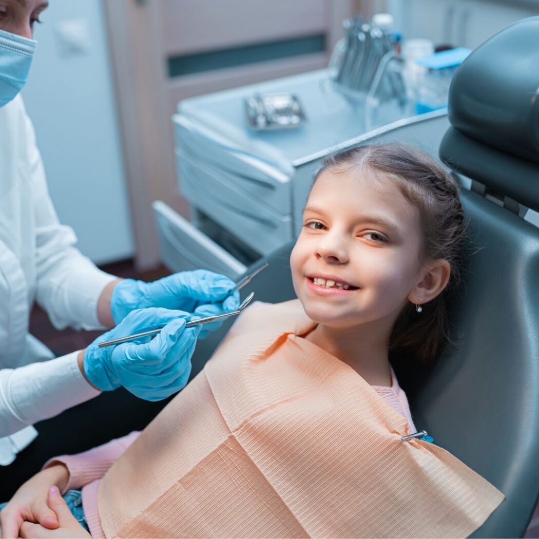 A smiling girl in the dental chair during a check-up