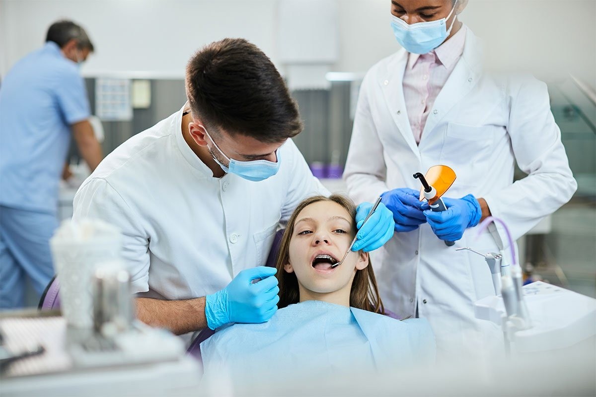 Two clinicians treating a teenage patient