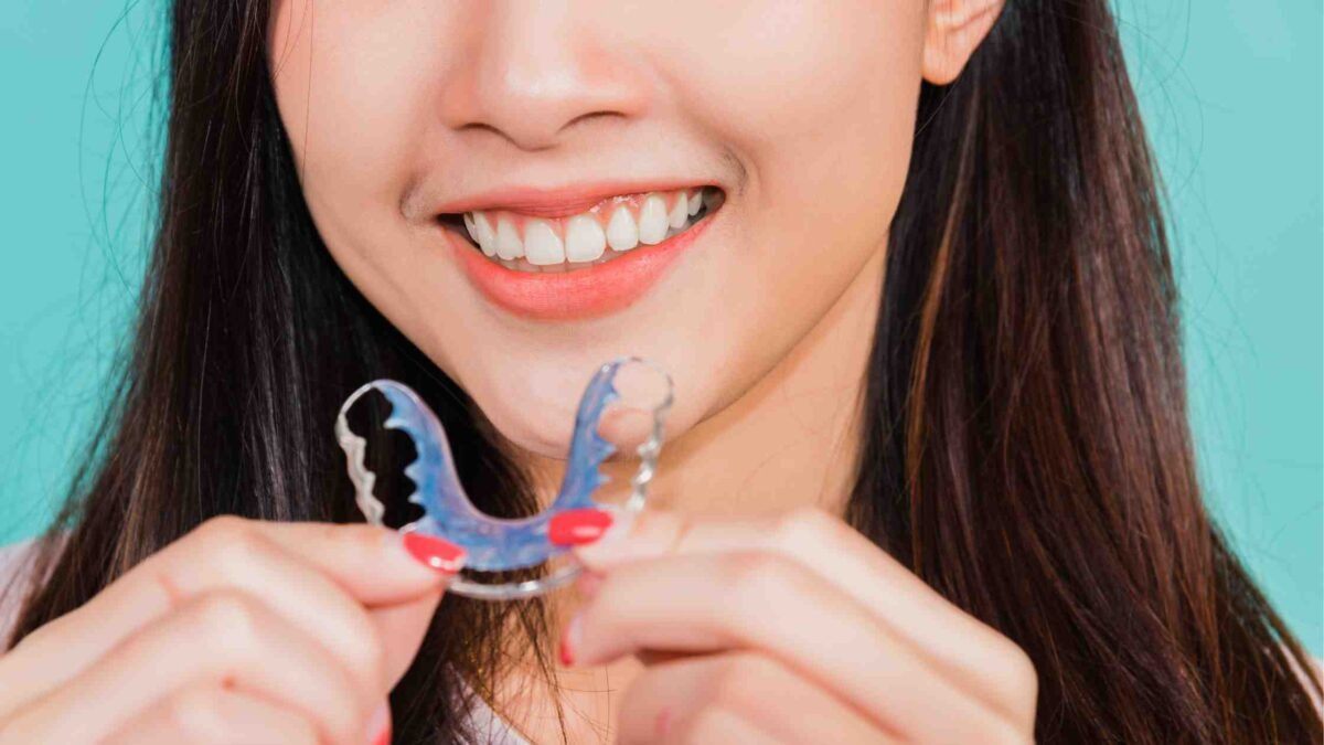 Adult woman patient holding retainer